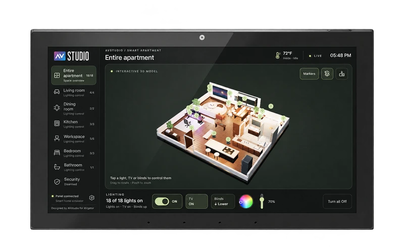 AVS-10 touchscreen panel showing AVstudio’s 3D apartment interface with room navigation, lighting, TV, and blinds controls