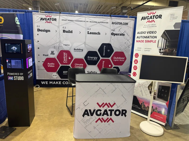 AVgator exhibition booth with a touch-panel demonstration stand, branded process backdrop, and freestanding touchscreen