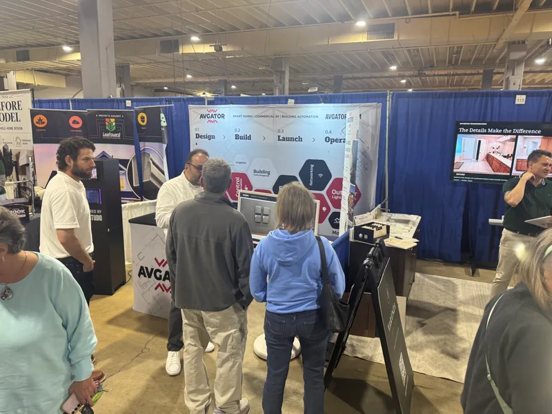 Visitors speaking with the AVgator team around the interactive display at the Charlotte Home Show